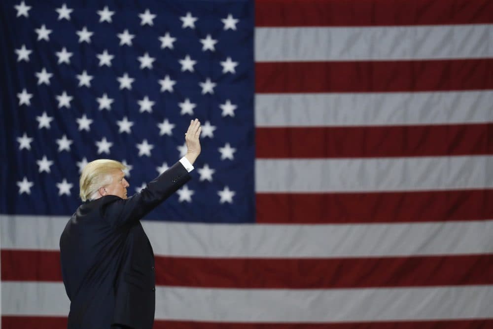 President Donald Trump waves in front of an American flag, March 20, 2017, in Louisville, Ky. (John Minchillo/AP)