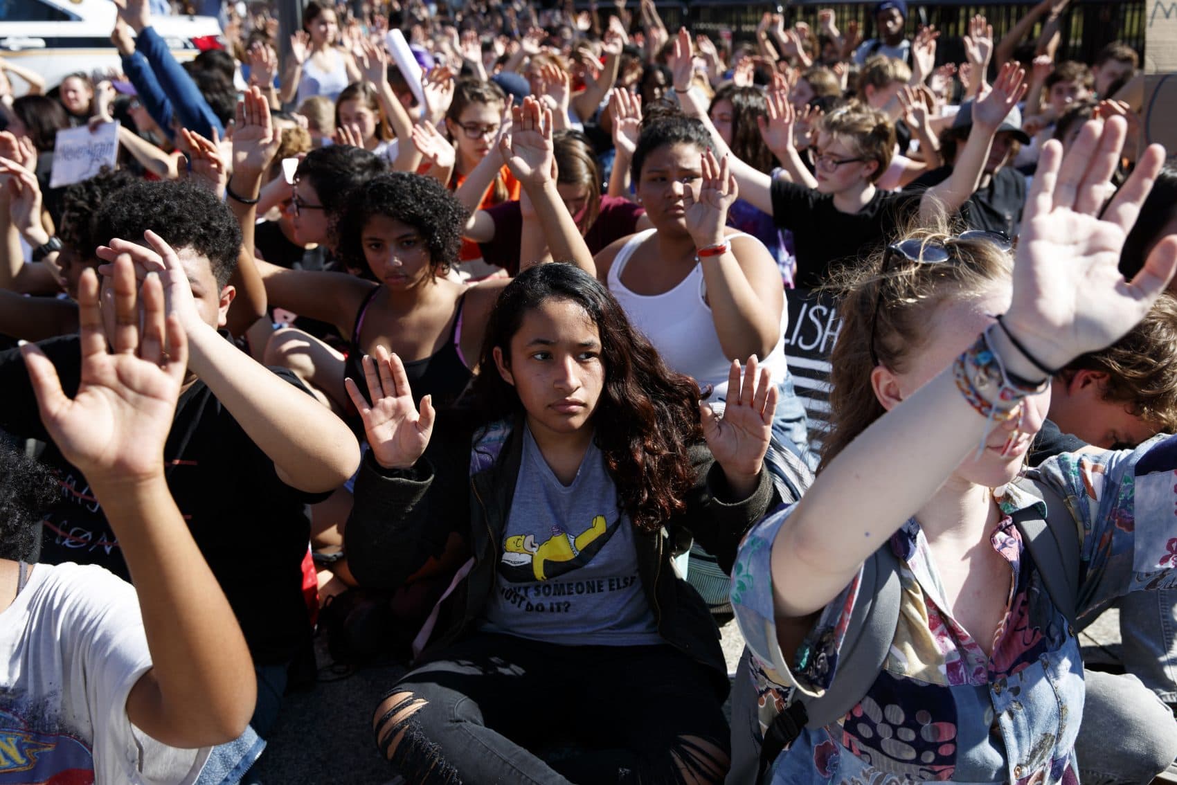 Demonstrators listen as the names of the victims of the Florida school shooting are read during a student protest for gun control legislation in front of the White House on Wednesday. (Evan Vucci/AP)