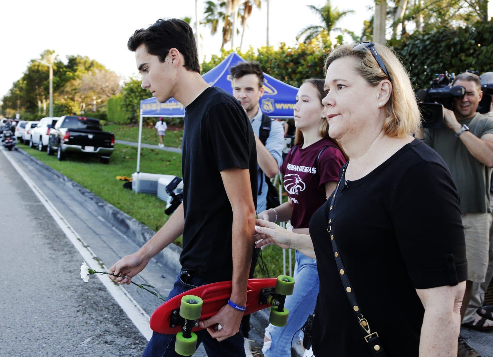 Marjory Stoneman Douglas High School student David Hogg, left, walks to class for the first time since a former student opened fire there with an assault weapon, Wednesday, Feb. 28, 2018, in Parkland, Fla. "This is a picture of education in fear in this country. The NRA wants more people just like this, with that exact firearm to scare more people and sell more guns," said Hogg, who has become a leading voice in the students' movement to control assault weapons .(Terry Renna/AP)
