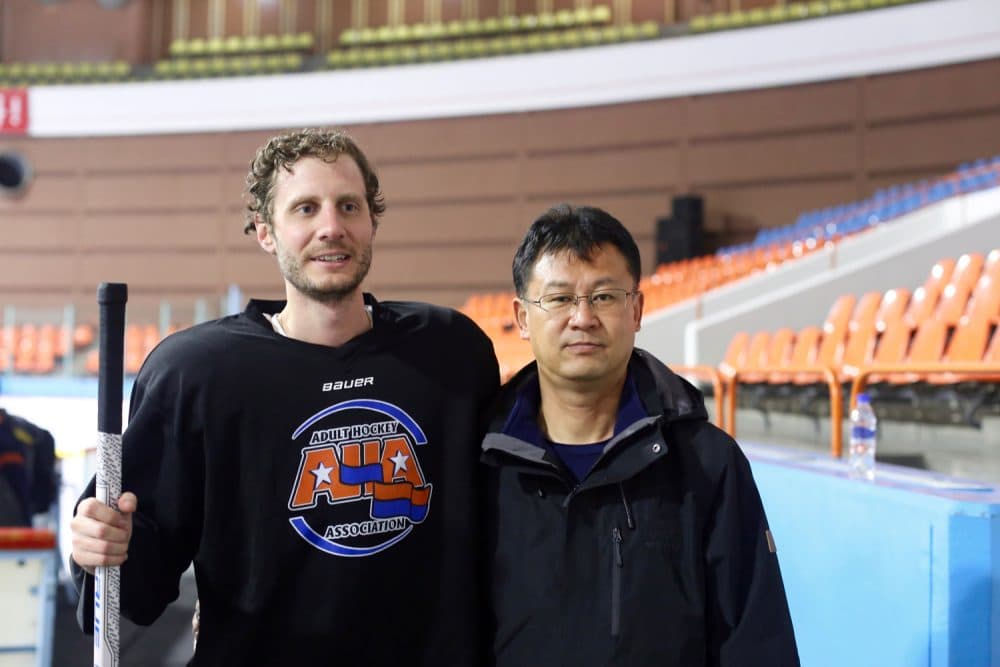 Alex stands rink-side in North Korea with the head coach of the men's national team, Yun Pong-chol. (Courtesy Alex Frecon)