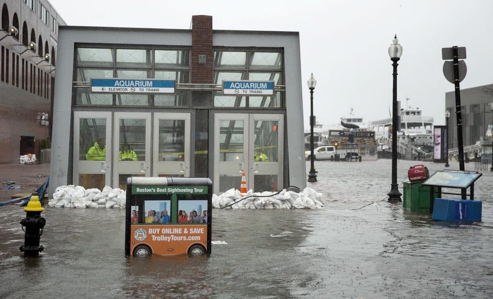 Sandbags hold back water at the entrance to the Aquarium MBTA station during the March 2 nor'easter. (Robin Lubbock/WBUR)