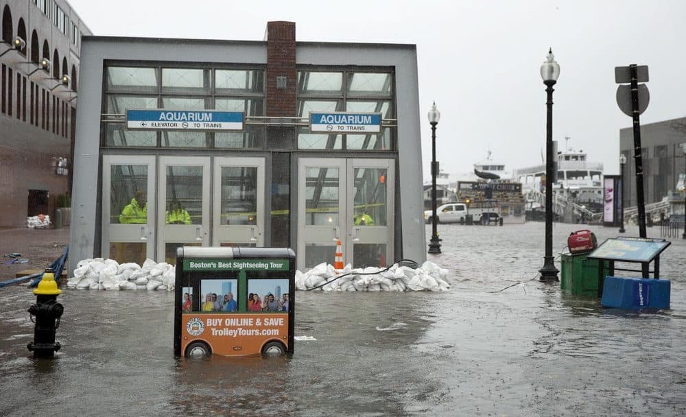 Sandbags hold back the water at the entrance to the Aquarium MBTA station. (Robin Lubbock/WBUR)