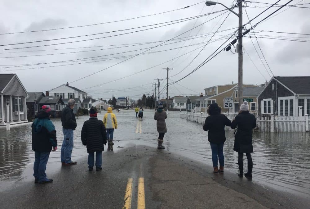 Residents of Marshfield, Mass. watch as the third and final high tide of the storm rolls in. (Bruce Gellerman/WBUR)