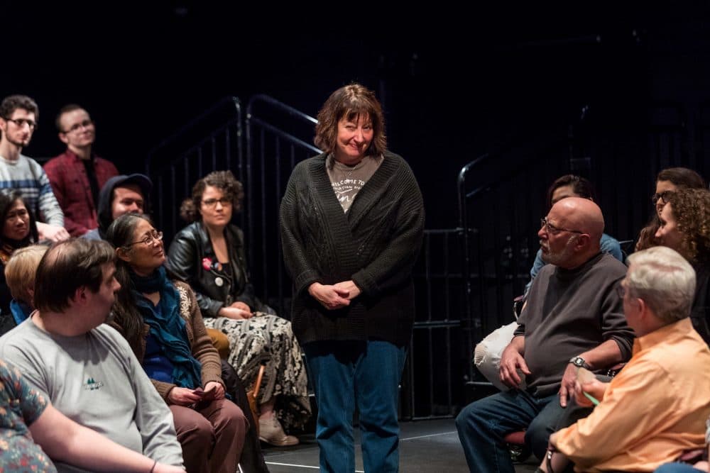 Adrianne Krstansky as The Narrator in SpeakEasy Stage's &quot;Every Brilliant Thing,&quot; with members of the audience. (Courtesy Maggie Hall Photography)