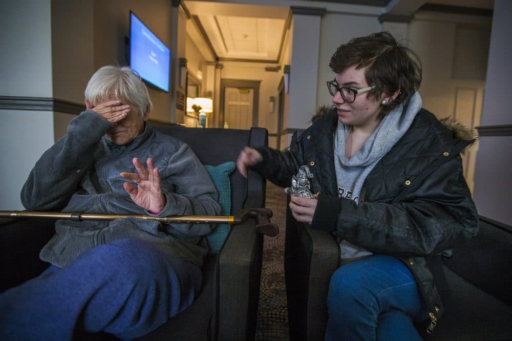 Taylor Fenton attends to her grandmother Gail as she gets upset talking about her grandson being taken away by Department of Children and Families. (Jesse Costa/WBUR)