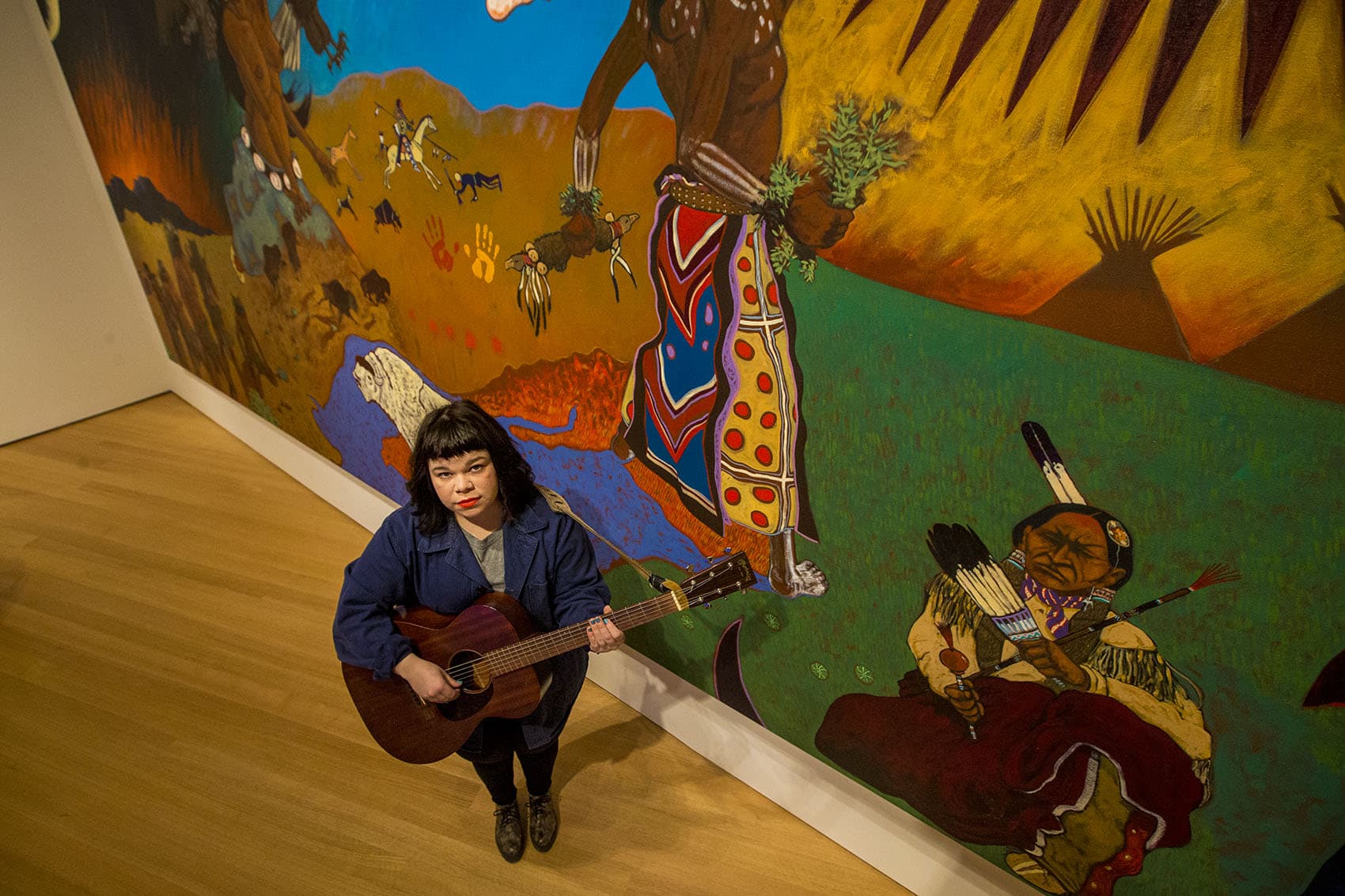 Here's musician Samantha Crain standing in front of Cannon's massive mural at the PEM. (Jesse Costa/WBUR)