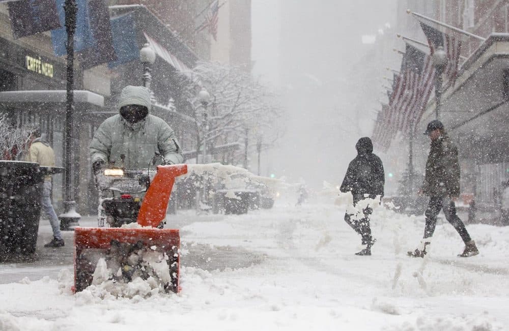 A snowblower keeps sidewalks clear on Summer Street in Boston. (Robin Lubbock/WBUR)