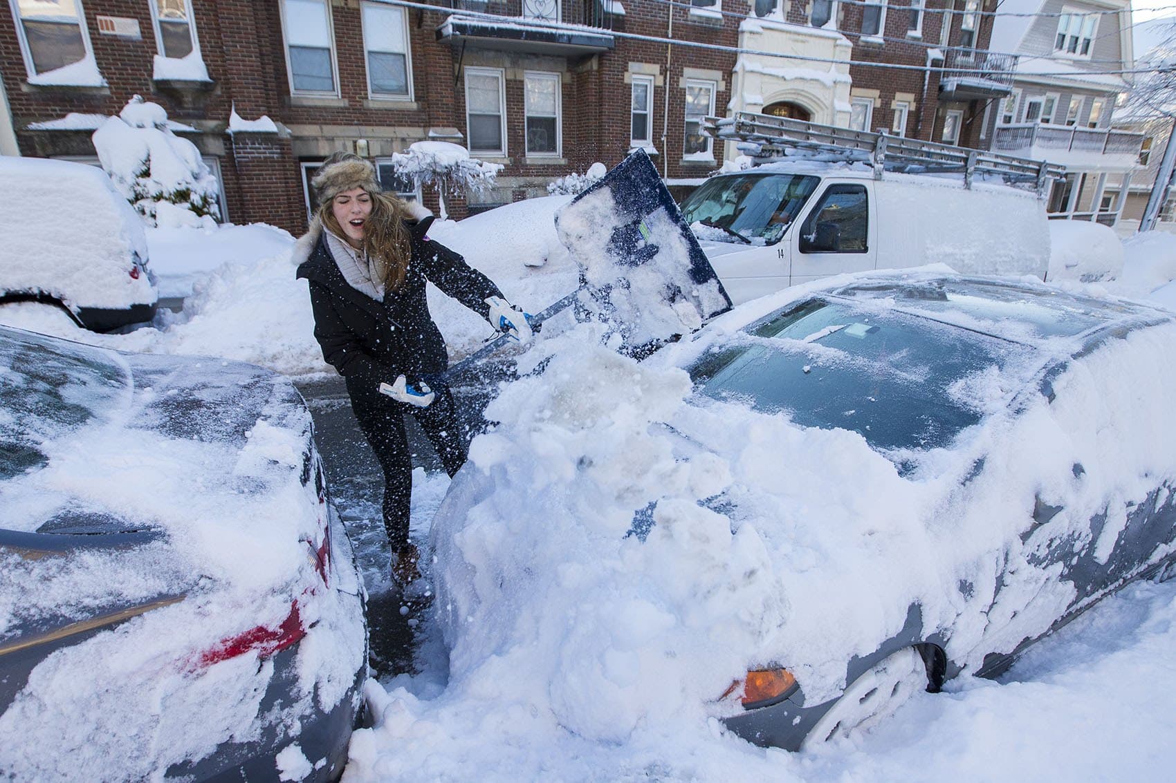 Karissa Medieros shovels her car out of the snow on Quint Street in Allston. (Jesse Costa/WBUR)