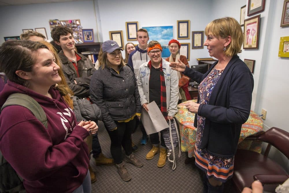 A group of Andover High School students speak with state Sen. Barbara L'Italien at her office in the State House. (Jesse Costa/WBUR)