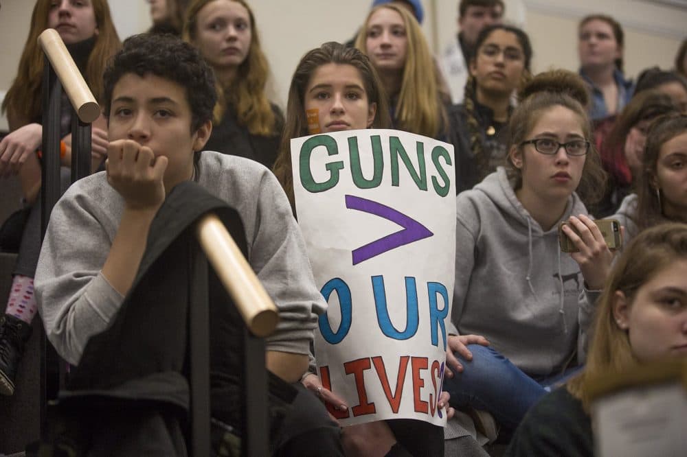 Students watch and listen to other student speeches demanding action against gun violence. (Jesse Costa/WBUR)