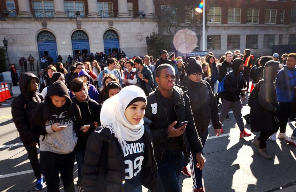 Hundreds of students walk out of Midwood High School as part of the nationwide protest against gun violence Wednesday in the Brooklyn borough of New York. (Mark Lennihan/AP)