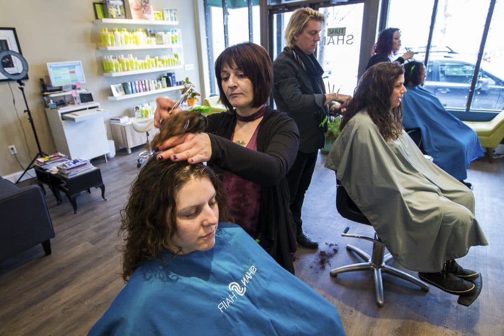 Hairstylist Antonella Deluca works on Margaret O'Connor's hair at Shan Hair in Brookline. (Jesse Costa/WBUR)