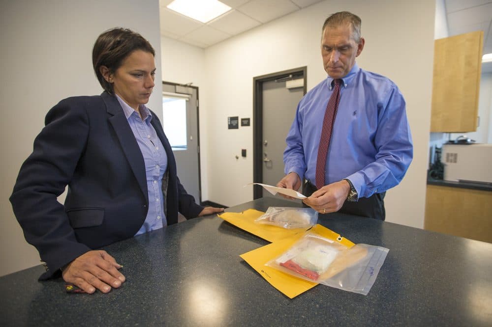 Arlington Police Chief Fred Ryan, right, and inspector Gina Bassett review toxicology reports on cocaine evidence, looking for the possibility of fentanyl. &quot;Law enforcement tells us that the next wave of the addiction crisis is fentanyl-laced cocaine,&quot; Ryan says. (Jesse Costa/WBUR)