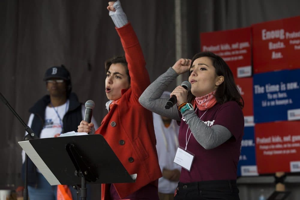Sisters Leonor, left, and Beca Muñoz speak to the crowd at the Boston Common. Beca graduated from Marjory Stoneman Douglas High School to go to Northeastern. Her sister, Leonor, still goes there. (Jesse Costa/WBUR)