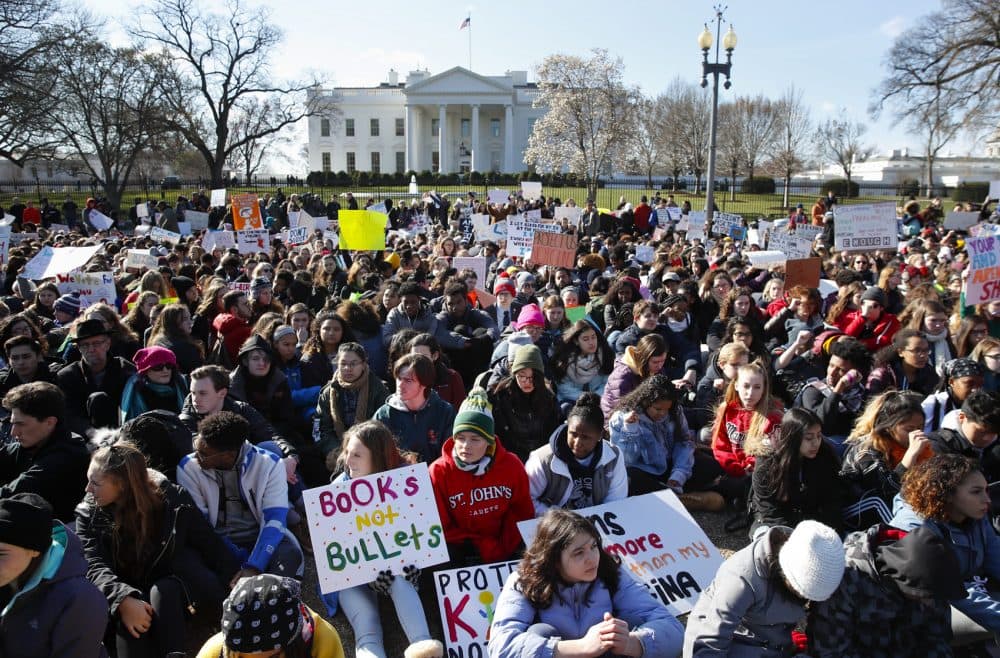Students walked out of classes to protest gun violence on the one-month anniversary of the Parkland, Fla. school shooting. Here, students sit in silence as they rally in front of the White House in Washington. (Carolyn Kaster/AP)
