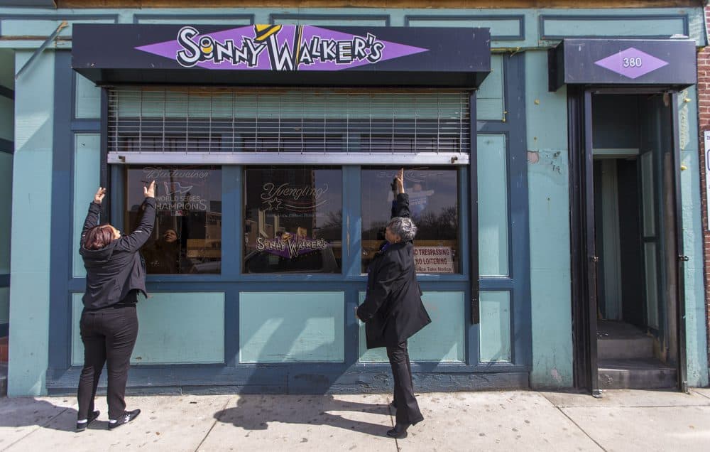 Mia McIlvany and Andrea Walker open the doors of Sonny Walker's in Roxbury for business. (Jesse Costa/WBUR)