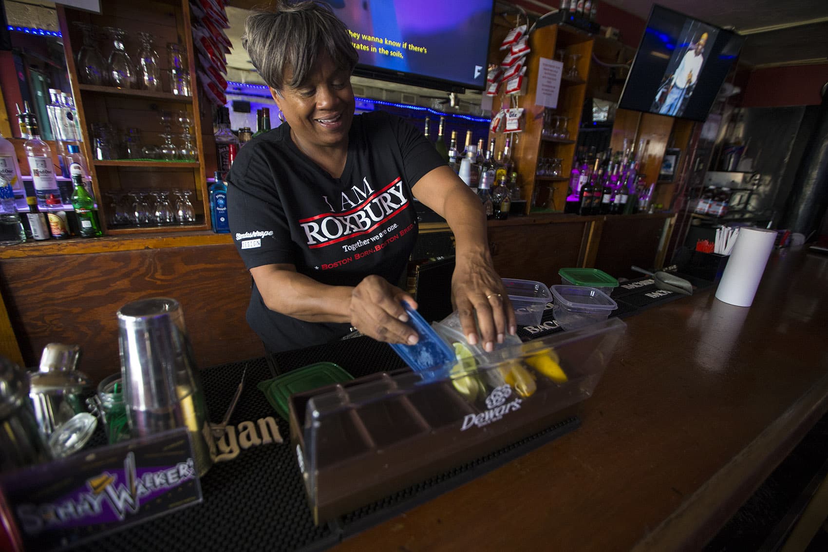 Andrea Walker preps the bar at Sonny Walker's before opening. (Jesse Costa/WBUR)