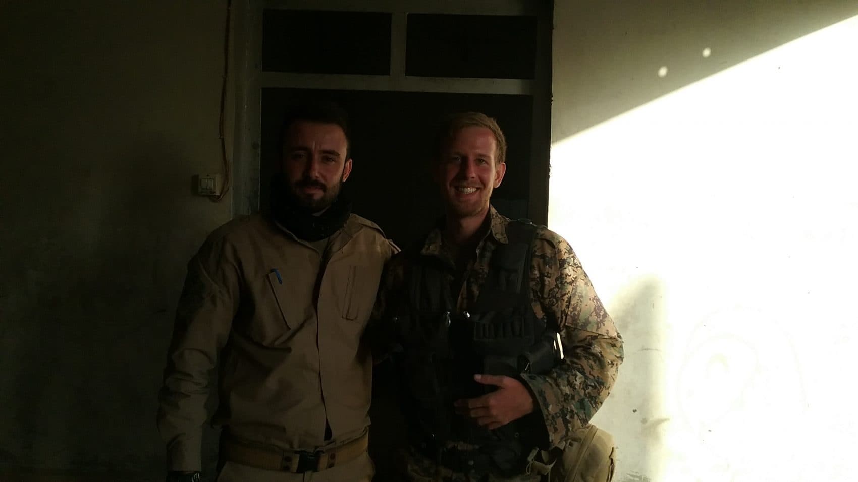 Caleb Stevens (right) in Raqqa with Mehmed, a Kurdish friend who was also fighting there. The picture was taken just after the ISIS forces in the city surrendered. (Courtesy Caleb Stevens)