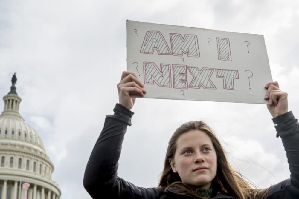 A woman holds a sign during a student led gun control rally outside the Capitol Building in Washington, Wednesday, March 14, 2018. Students walked out of school to protest gun violence in the biggest demonstration yet of the student activism that has emerged in response to last month's massacre of 17 people at Florida's Marjory Stoneman Douglas High School. (Andrew Harnik/AP)