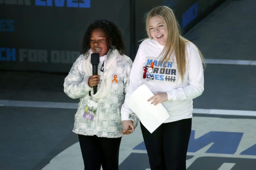 Yolanda Renee King, grand daughter of Martin Luther King Jr., left, speaks as Jaclyn Corin, a student at Marjory Stoneman Douglas High School in Parkland, Fla., and one of the organizers of the rally, holds hands with her during the &quot;March for Our Lives&quot; rally in support of gun control, Saturday, March 24, 2018, in Washington. (Alex Brandon/AP)