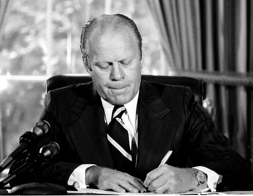 President Gerald Ford signs a document granting former President Richard M. Nixon "a full, free and absolute pardon" for all "offenses against the United States" during the period of his presidency. Ford signed the document on Sept. 8, 1974. (AP)