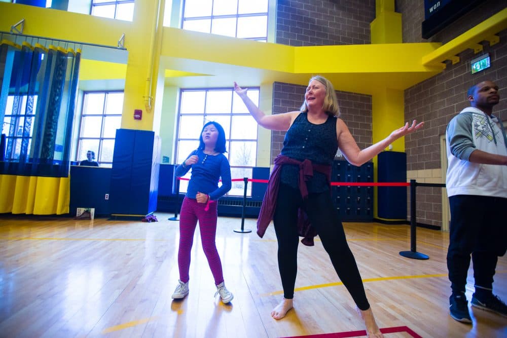 At the Ailey community dance workshop, the author strikes a pose as her daughter pretends not to notice. (Courtesy Robert Torres/Celebrity Series)