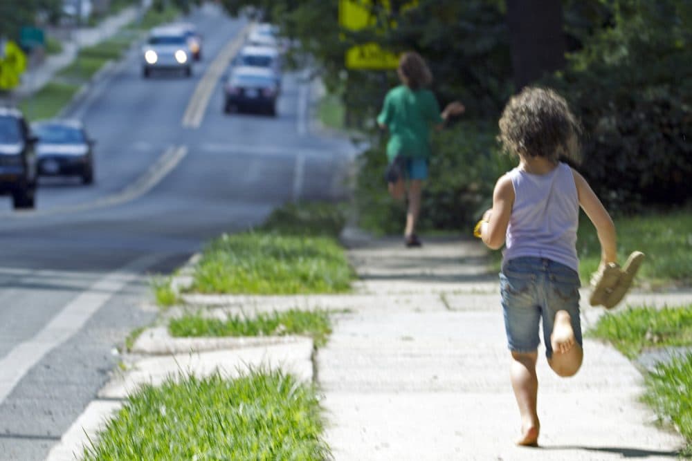 Dvora Meitiv, 6, runs home with her brother Rafi 10, after their mother Danielle Meitiv,pick them up at the school bus stop in Silver Spring Md., on Friday, June 12, 2015. After outcry over one familys free-range parenting case, Maryland officials on Friday clarified the states policy on how authorities handle cases of children walking or playing alone outdoors, saying the state shouldnt investigate unless kids are harmed or face substantial risk of harm. (AP Photo/Jose Luis Magana)