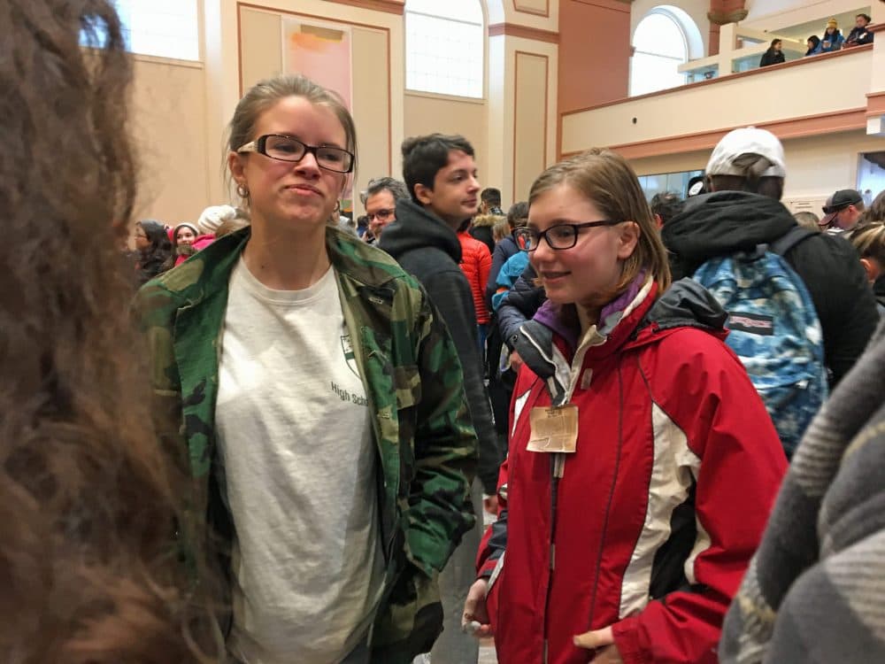 Jaeda Hamel, left, and Laura Lewis of Medford meet before the March 14 rally at the Cathedral Church of St. Paul in Boston. (Max Larkin/WBUR)