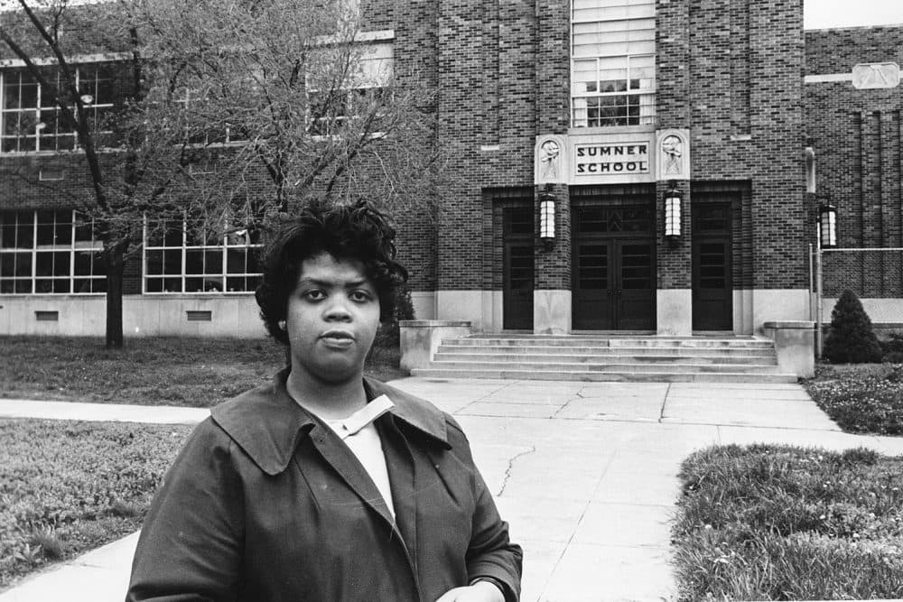 FILE - This May 8, 1964 file photo shows Linda Brown Smith standing in front of the Sumner School in Topeka, Kansas. The refusal of the public school to admit Brown in 1951, then nine years old, because she is black, led to the Brown v. Board of Education of Topeka, Kansas. In 1954, the U.S. Supreme Court overruled the "separate but equal" clause and mandated that schools nationwide must be desegregated. (AP Photo, File)