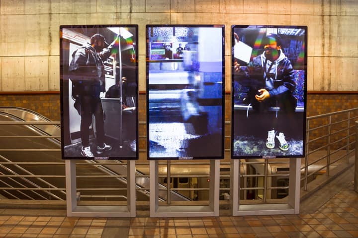 Sydney A. Bobb's video, &quot;Fraternal Eclipse,&quot; on screen in an MBTA station. (Courtesy MBTA)