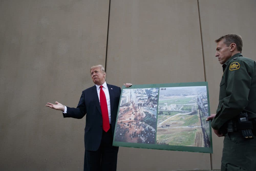 President Donald Trump talks with reporters as he gets a briefing on border wall prototypes, Tuesday, March 13, 2018, in San Diego. (AP Photo/Evan Vucci)