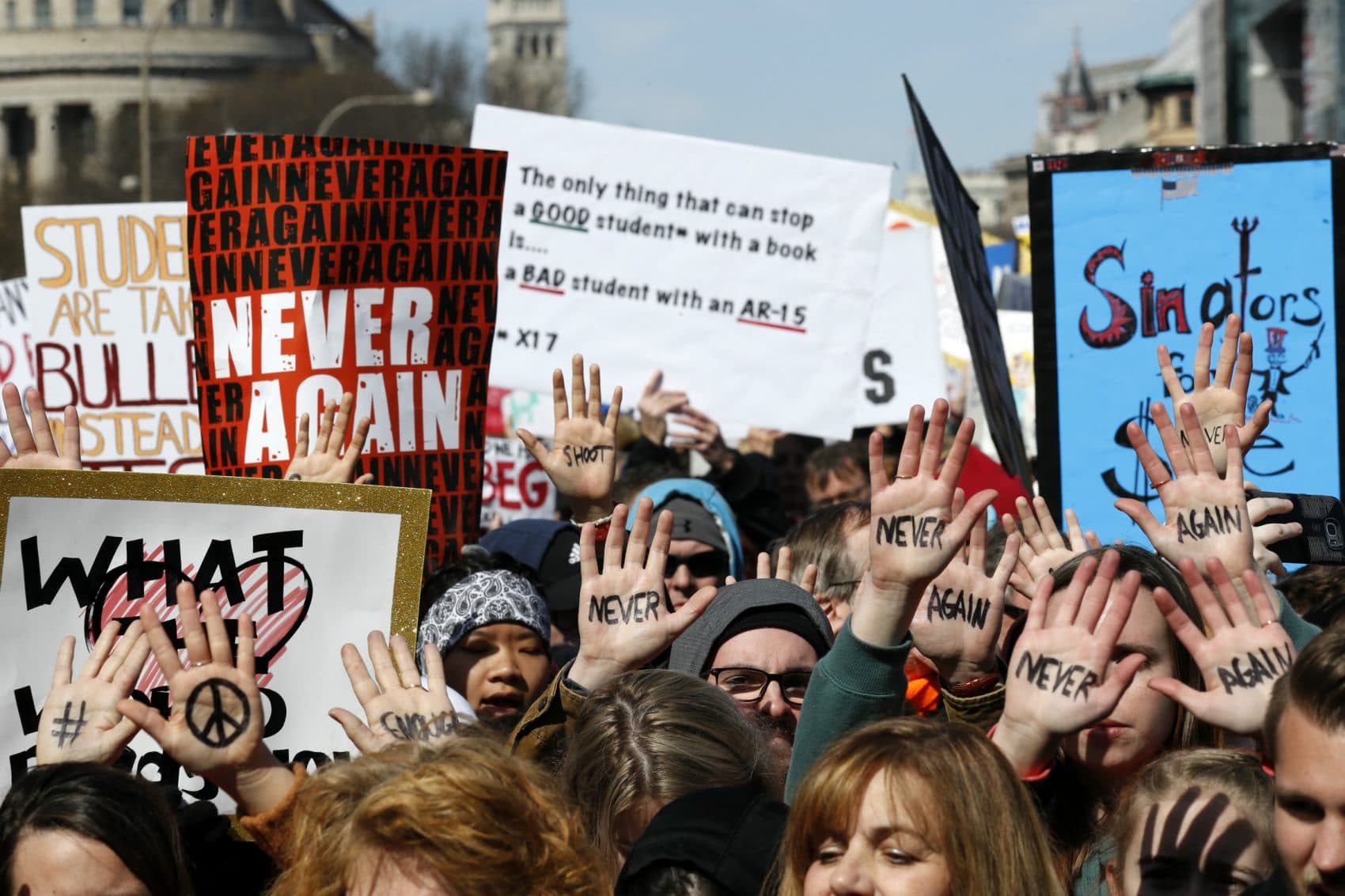 People hold their hands up with messages written on them during the "March for Our Lives" rally in support of gun control, Saturday, March 24, 2018, in Washington. (Alex Brandon/AP)