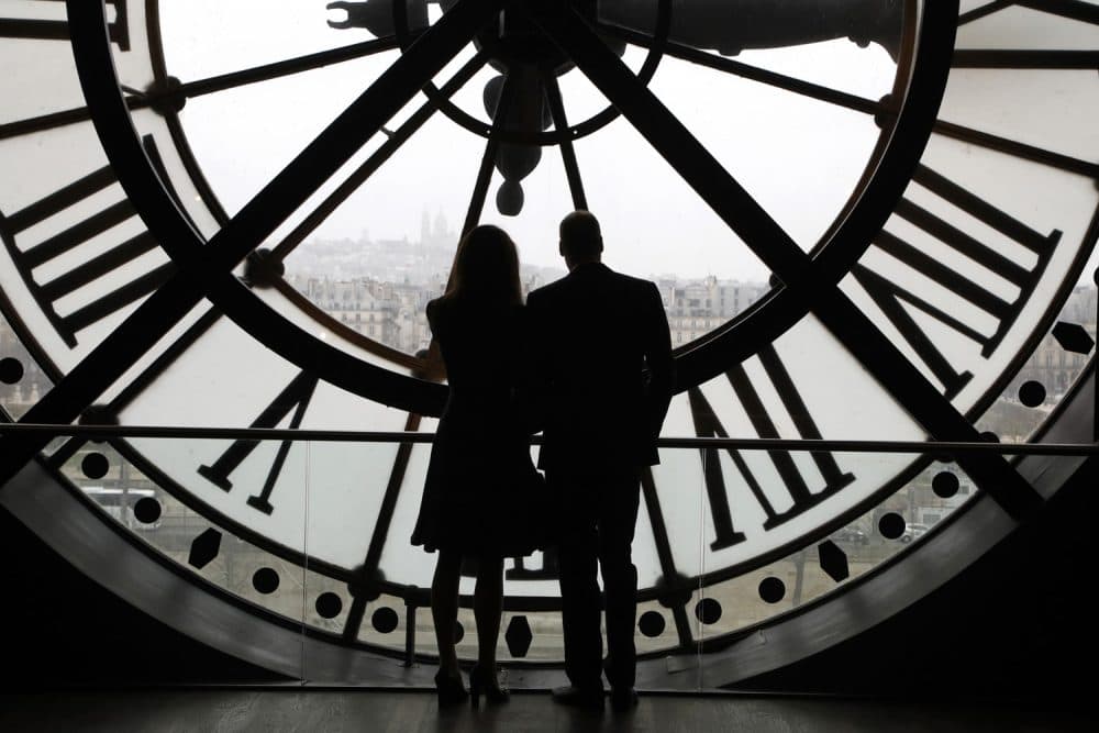 Britain's Prince William, Duke of Cambridge, and his wife Britain's Kate, Duchess of Cambridge, are silhouetted as they look the Seine river through a giant clock at the Musee d'Orsay museum -the former Gare d'Orsay train station- during their visit to the museum, Saturday, March 18, 2017, on the second day of their two-day visit to the French capital. (Francois Guillot/Pool Photo via AP)