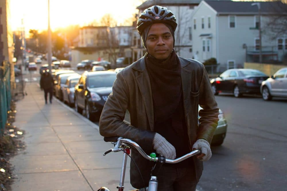 Noah De Amor stands with his bike outside Bowdoin Bike School, in this 2016 file photo. (Hadley Green for WBUR)