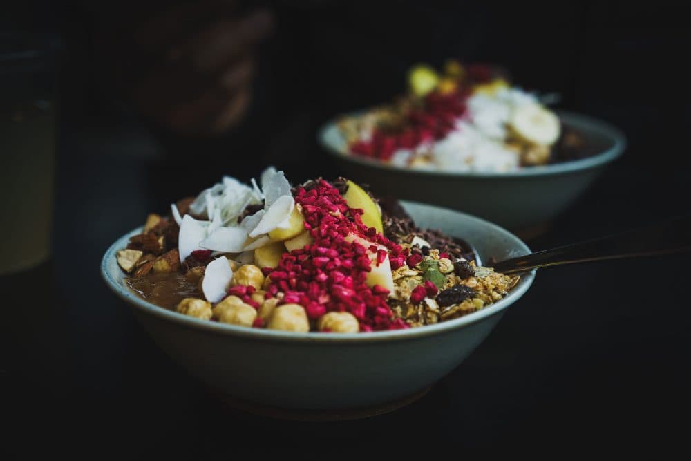 Healthy fruit bowls with coconut, berries and nuts. (Arek Adeoye/Unsplash)