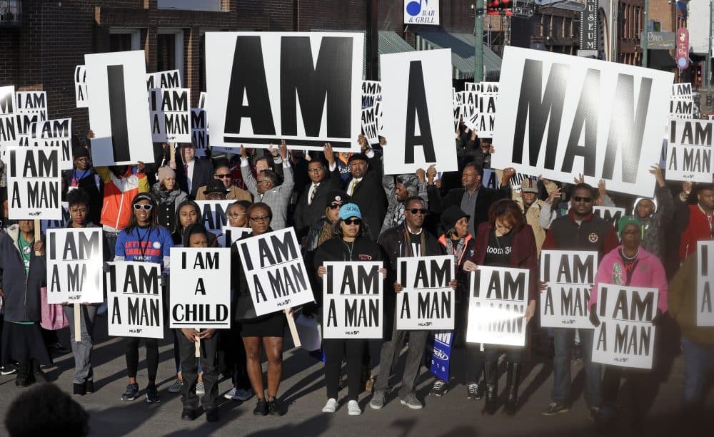 People hold signs resembling the signs carried by striking sanitation workers in 1968 as they join in events commemorating the 50th anniversary of the assassination of the Rev. Martin Luther King Jr. on Wednesday in Memphis, Tenn. (Mark Humphrey/AP)