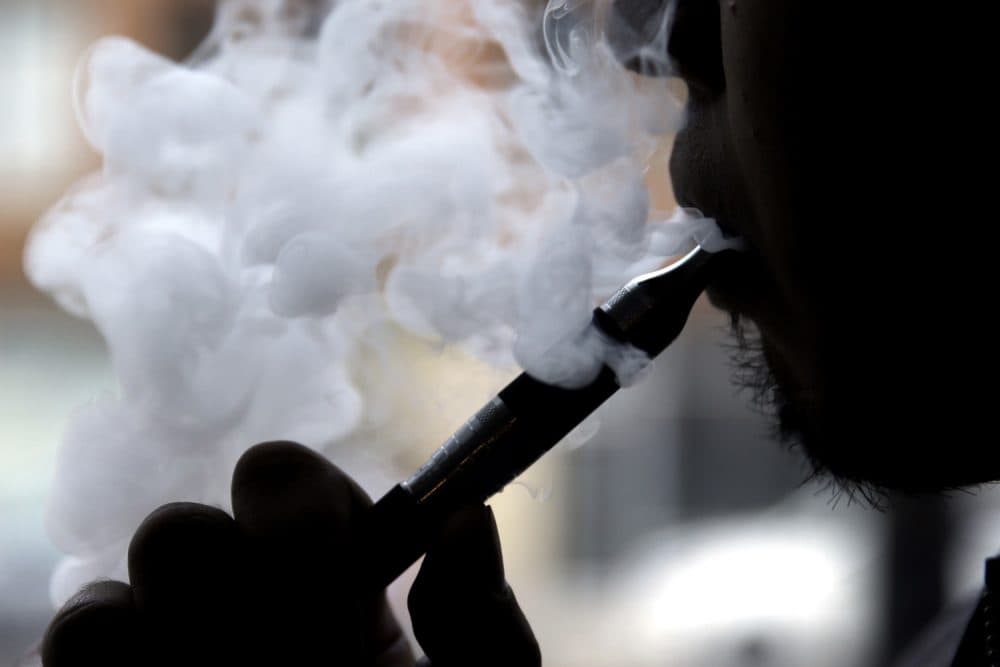 A man smokes an electronic cigarette. (Nam Y. Huh/AP)