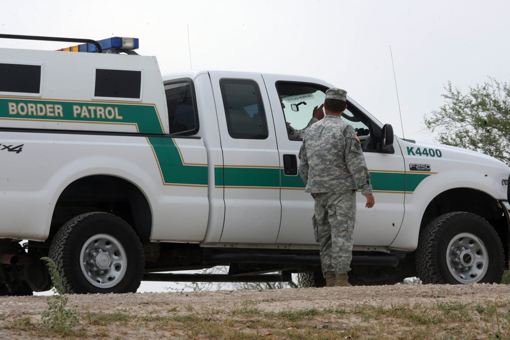 In this April 19, 2011 photo, a National Guardman talks with U.S. Border Patrol agents stationed along the Hidalgo International Bridge in Hidalgo, Texas. (Delcia Lopez/AP)