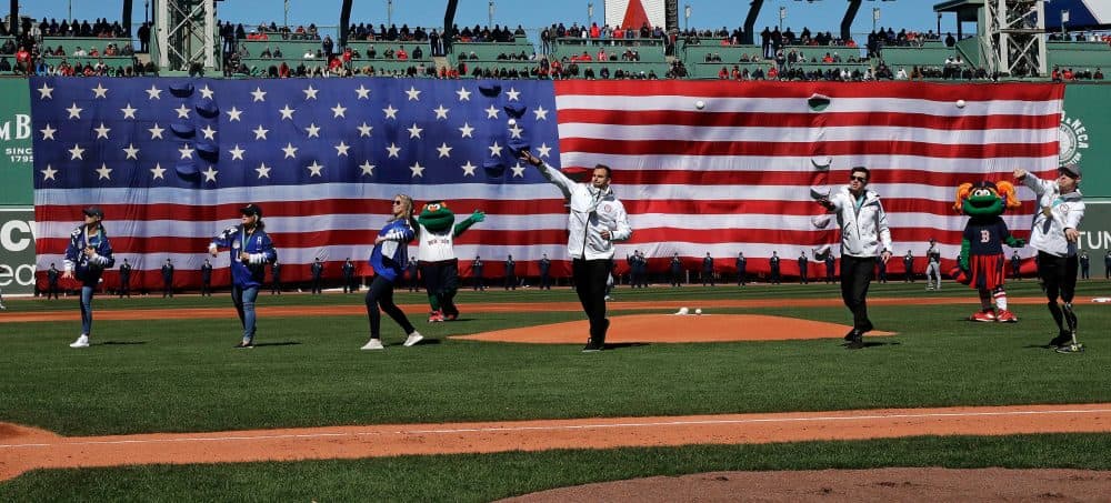 Winter Olympic athletes throw out the ceremonial first pitch during ceremonies prior to a home opener. (Charles Krupa/AP)