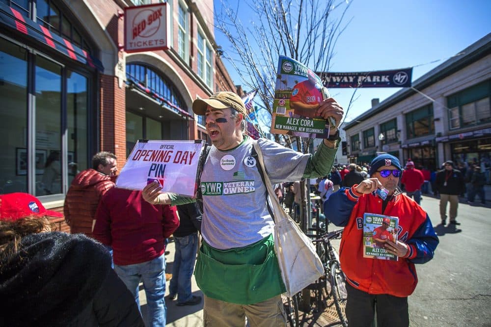 Sly Egigio sells Red Sox programs on the corner of Brookline Avenue. This is his 25th Opening Day, and he says this is the coldest one he's ever experienced. (Jesse Costa/WBUR)