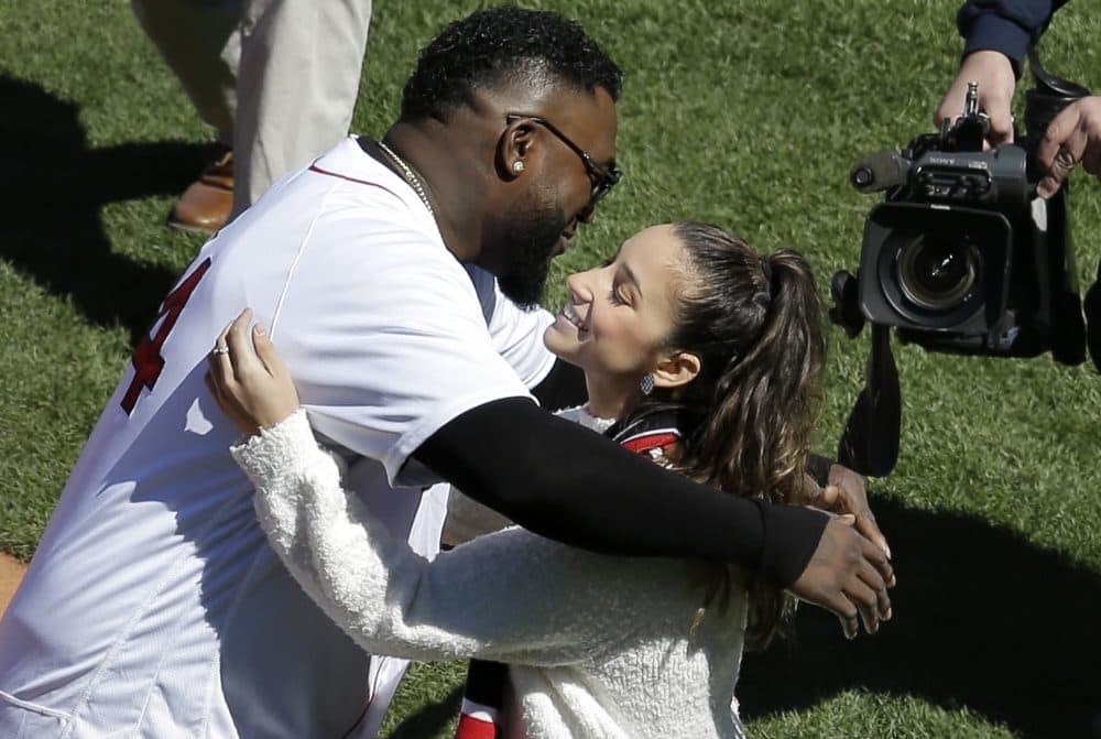 Former Boston Red Sox designated hitter David Ortiz, left, and Olympic gold medalist Aly Raisman embrace during ceremonies before the game. (Steven Senne/AP)
