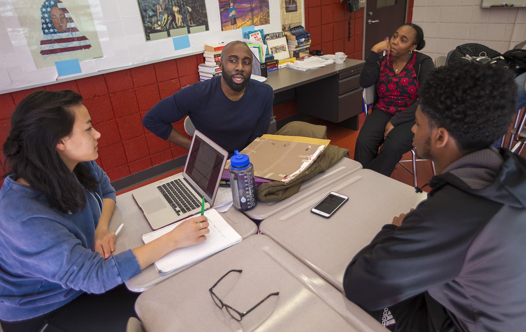 Cambridge Rindge and Latin School history teacher Kevin Dua, speaks with students of the Black Student Union. (Jesse Costa/WBUR)