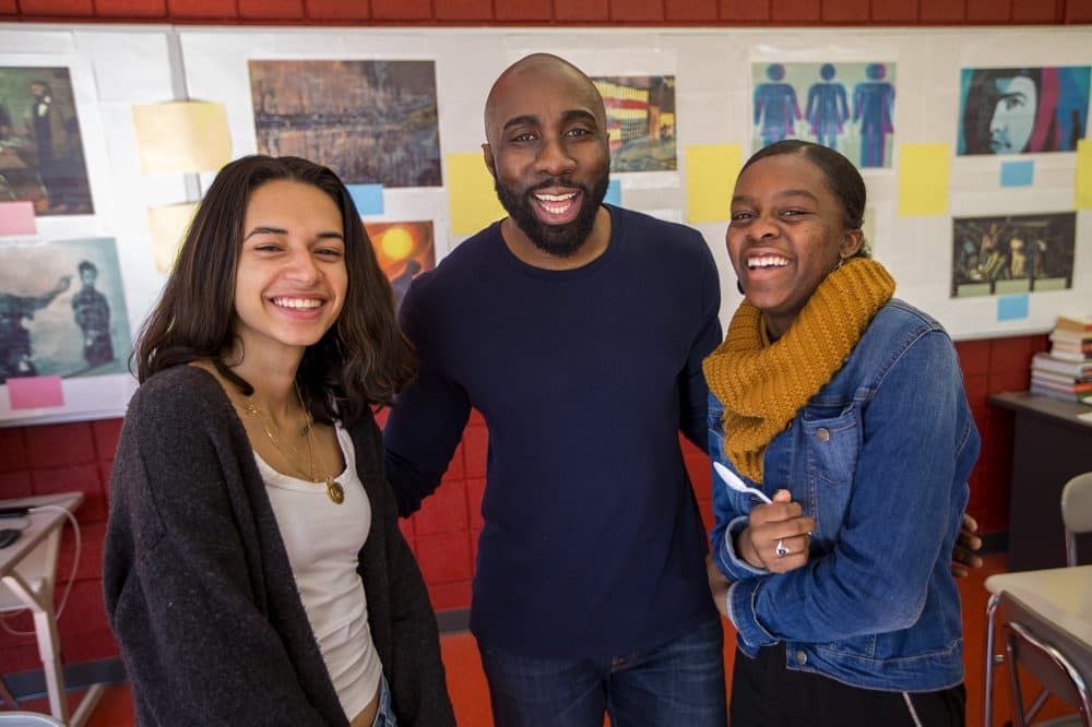Cambridge Rindge and Latin School history teacher Kevin Dua, flanked by Victoria Angeles, left, and Lorra Marseille, members of the Black Student Union. (Jesse Costa/WBUR)