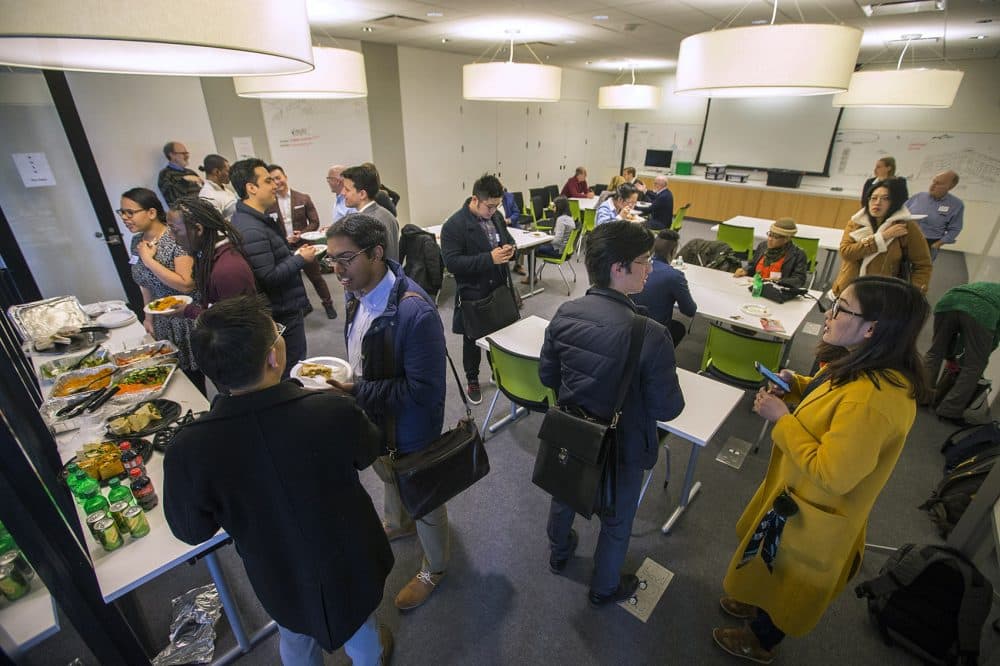 Investors and entrepreneurs talk during the networking luncheon portion of Smarter in the City's first investor pitch event held at the Roxbury Innovation Center. (Jesse Costa/WBUR)