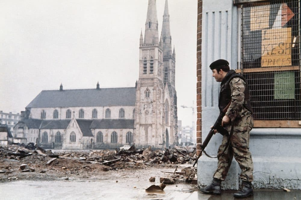 A British soldier patrols near a church on the edge of the Falls Road District of Belfast, Northern Ireland, on April 3, 1972. (AP Photo)