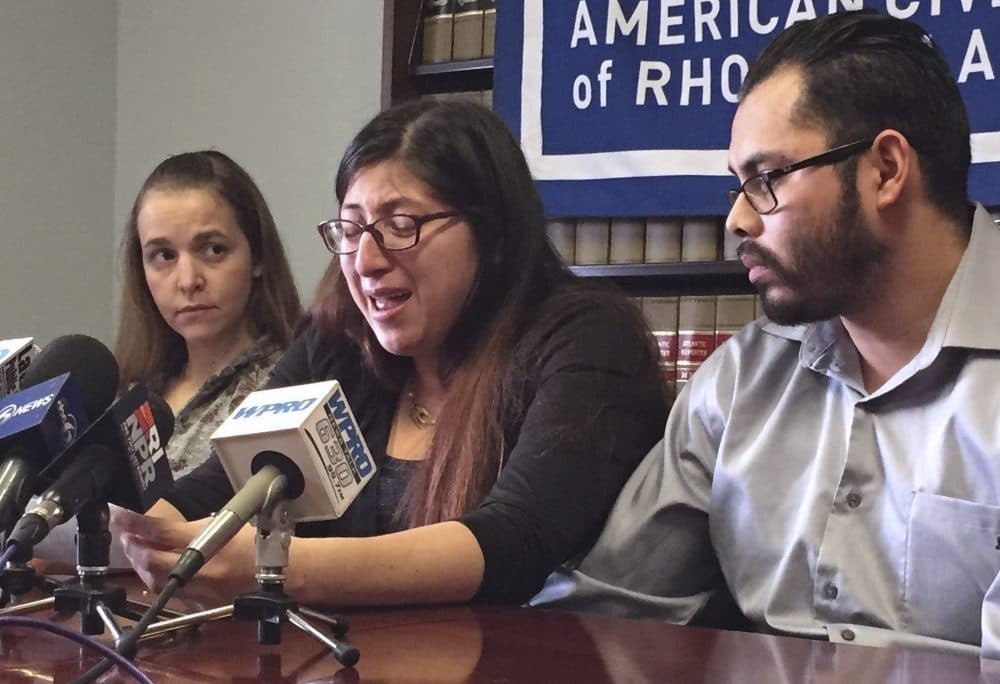 Lilian Calderon, center, cries as she describes her experiences while in custody, alongside her husband, Luis Gordillo, right, during a news conference at the office of the American Civil Liberties Union in Providence, R.I. in February. (Michelle R. Smith/AP)