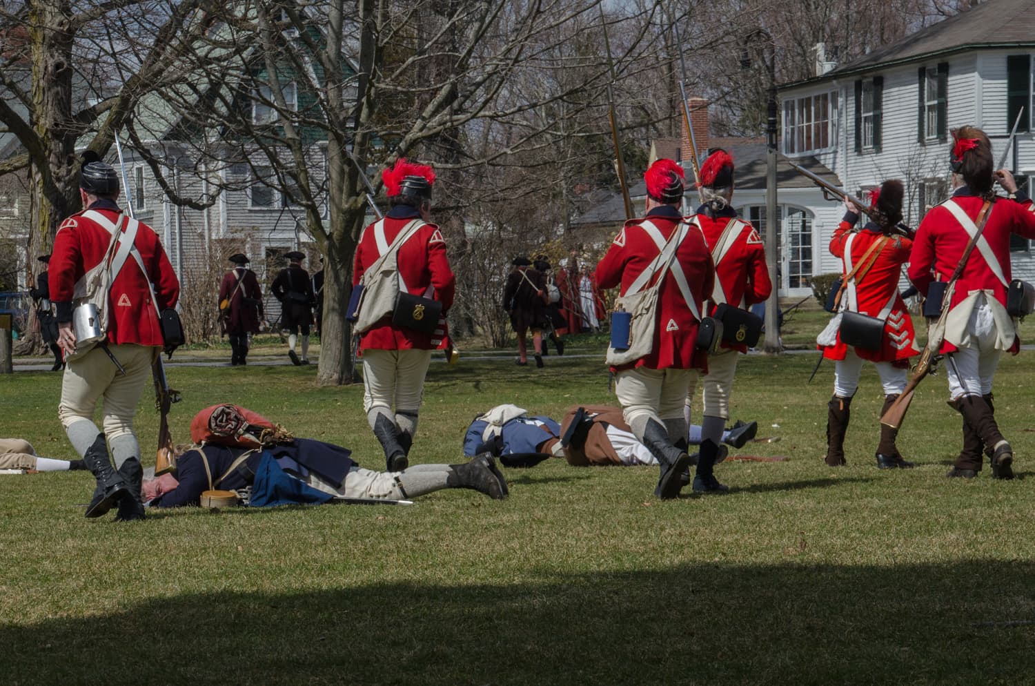 As the rehearsal concludes, the Redcoats march through the fallen on Lexington Green. (Sharon Brody/WBUR)