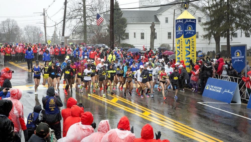 Boston Marathon elite women runners cross the starting line in Hopkinton. (Robin Lubbock/WBUR)