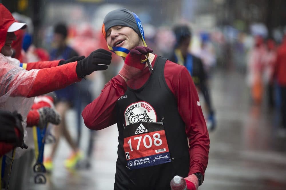 Brett Smith has a little trouble putting his medal around his head. (Jesse Costa/WBUR)