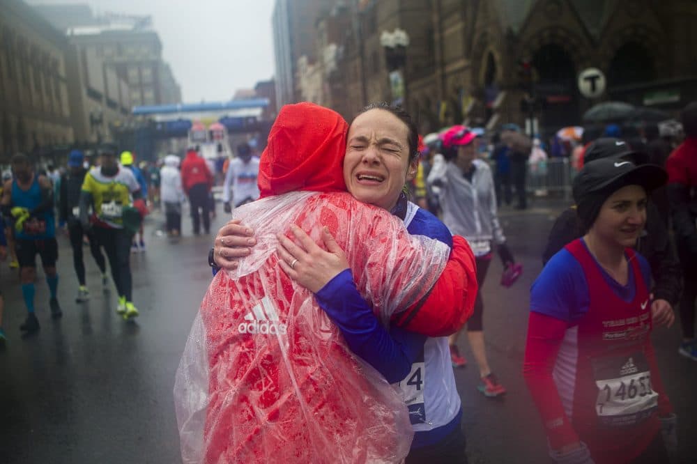 Alexandra Barak of Israel gets a congratulatory hug from Boston Marathon volunteer Angela Coulombe after finishing. (Jesse Costa/WBUR)